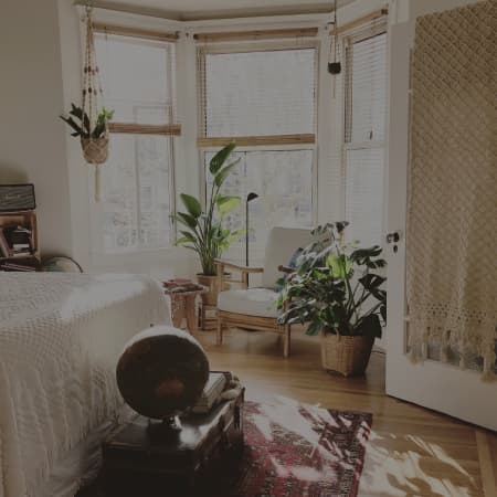 bedroom chair in front of windows