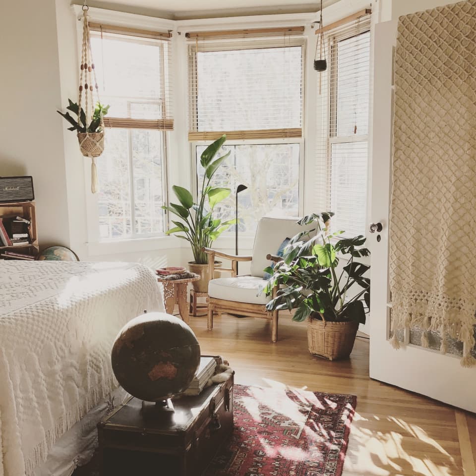 chair in bedroom in front of windows