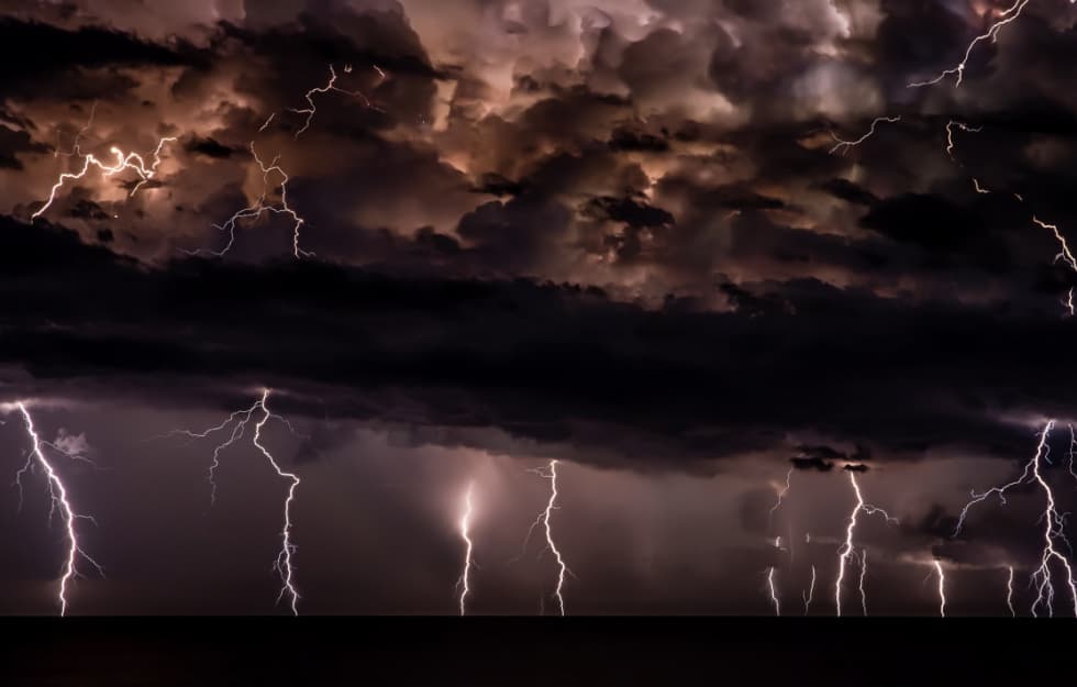 View of a dark storm with lightning flashing down