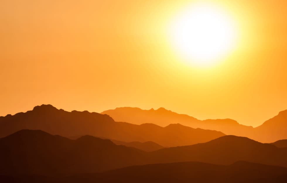 Shot of mountain and sun shining bright setting