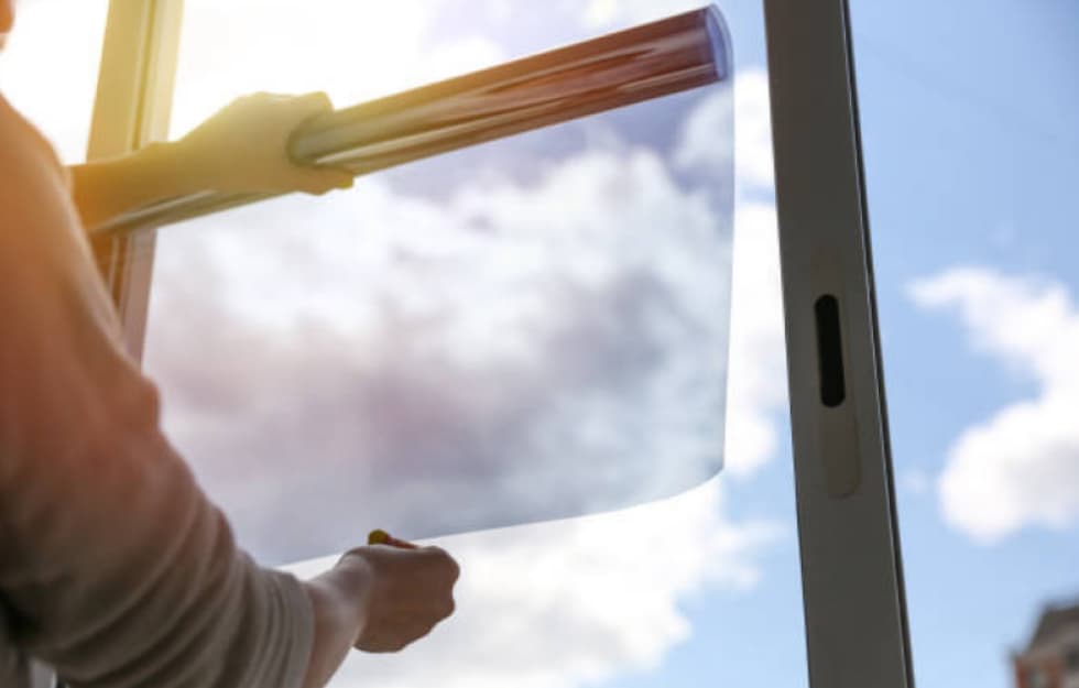 Person lining up window tint to apply