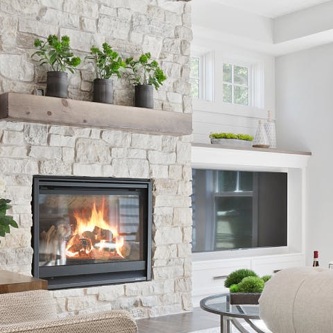 Fireplace in a ling room in a brick wall