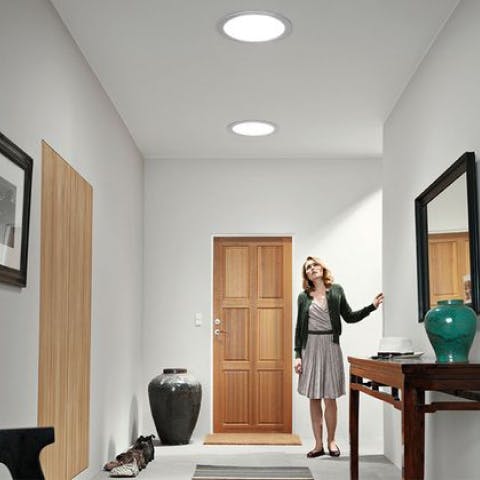 woman looking up to lights with mirror placement